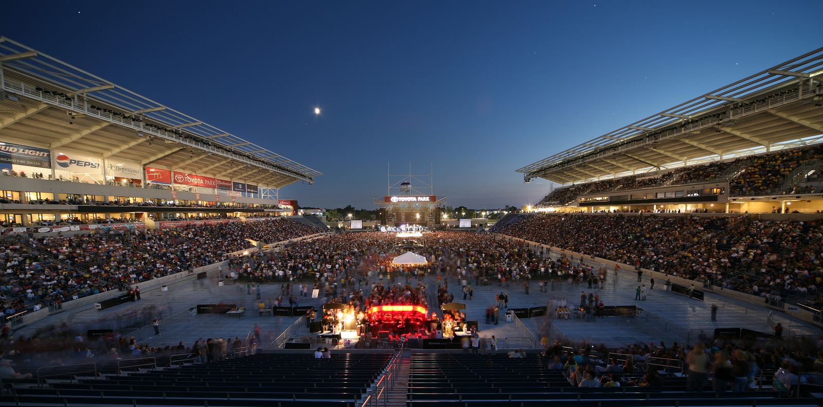 A panoramic view of a full Toyota Park at dusk in concert configuration.